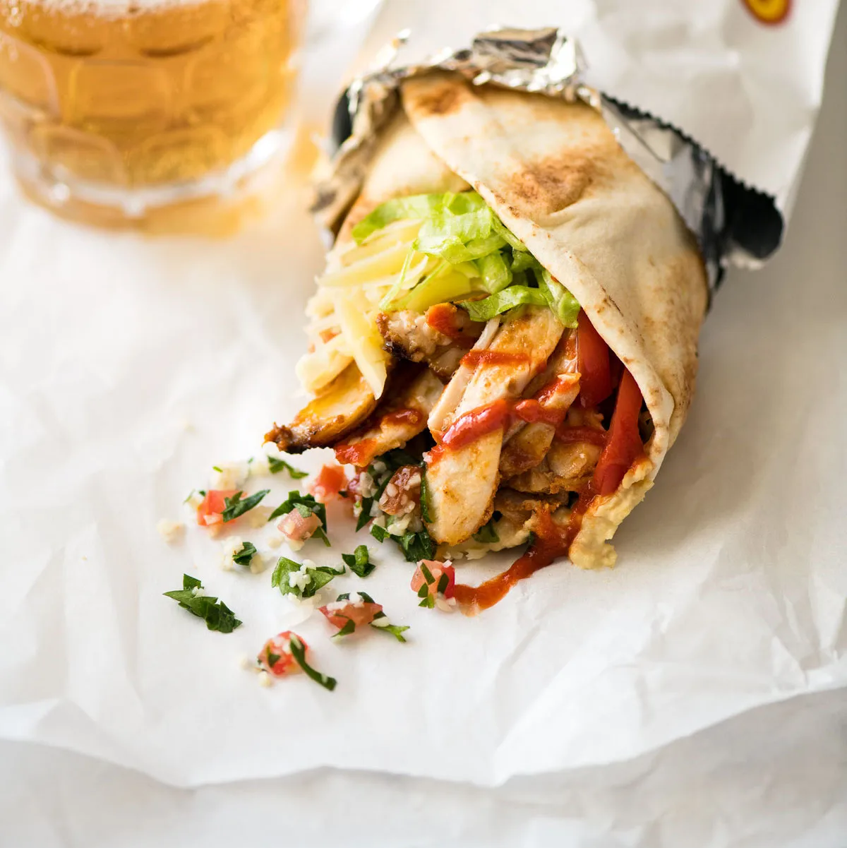 A street-style chicken kebab wrap ready to eat
